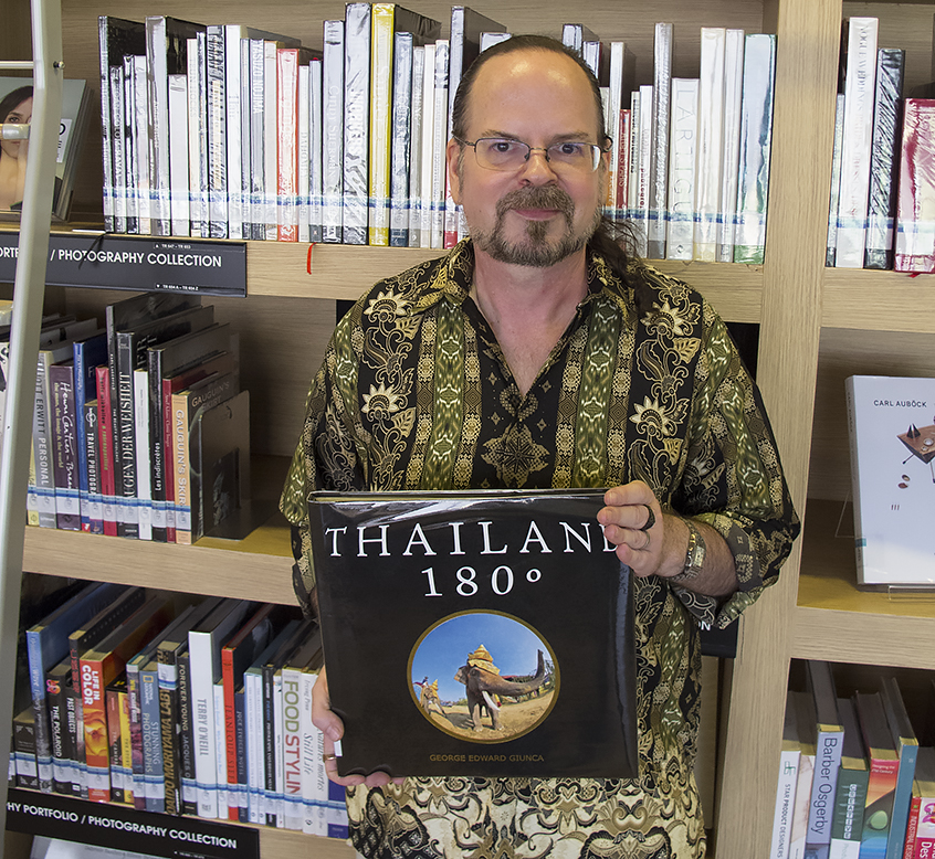 Image of George Edward Giunca with the THAILAND 180º book at the TCDC in Chiang Mai, Thailand